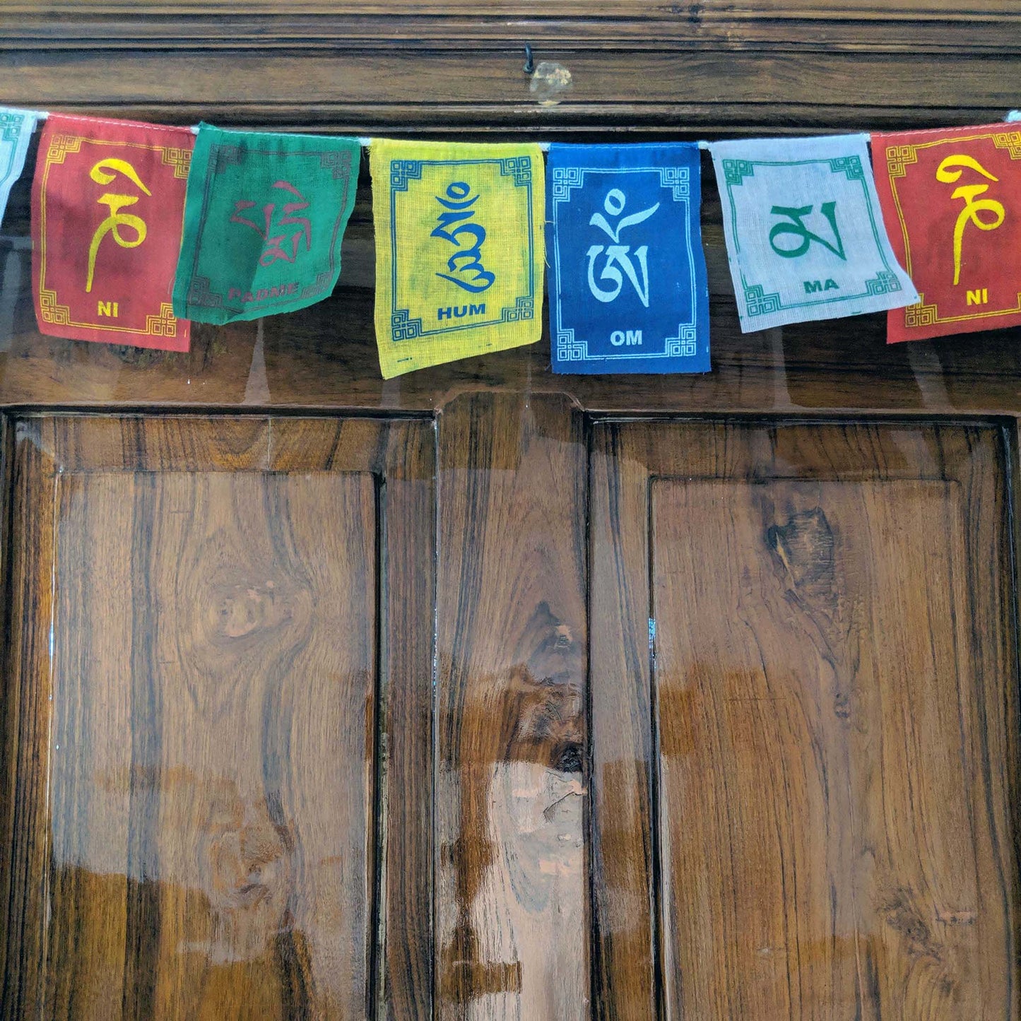 Prayer Flag Om Mani Padme Hum Cotton on home door closeup