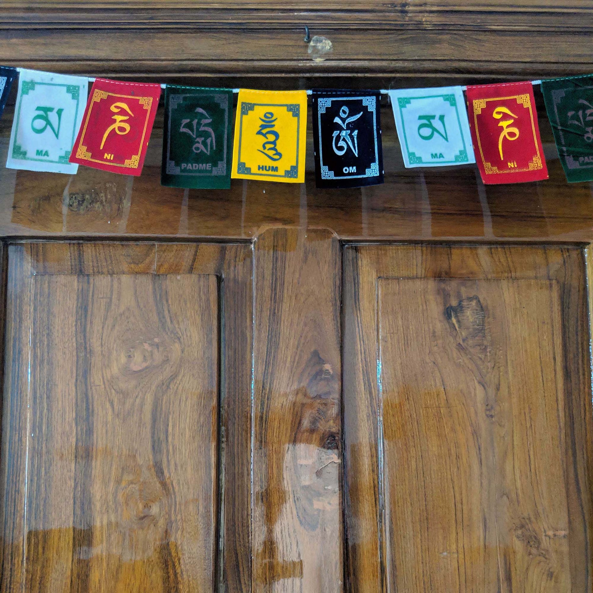 Prayer Flag Om Mani Padme Hum Velvet Mini on home door closeup