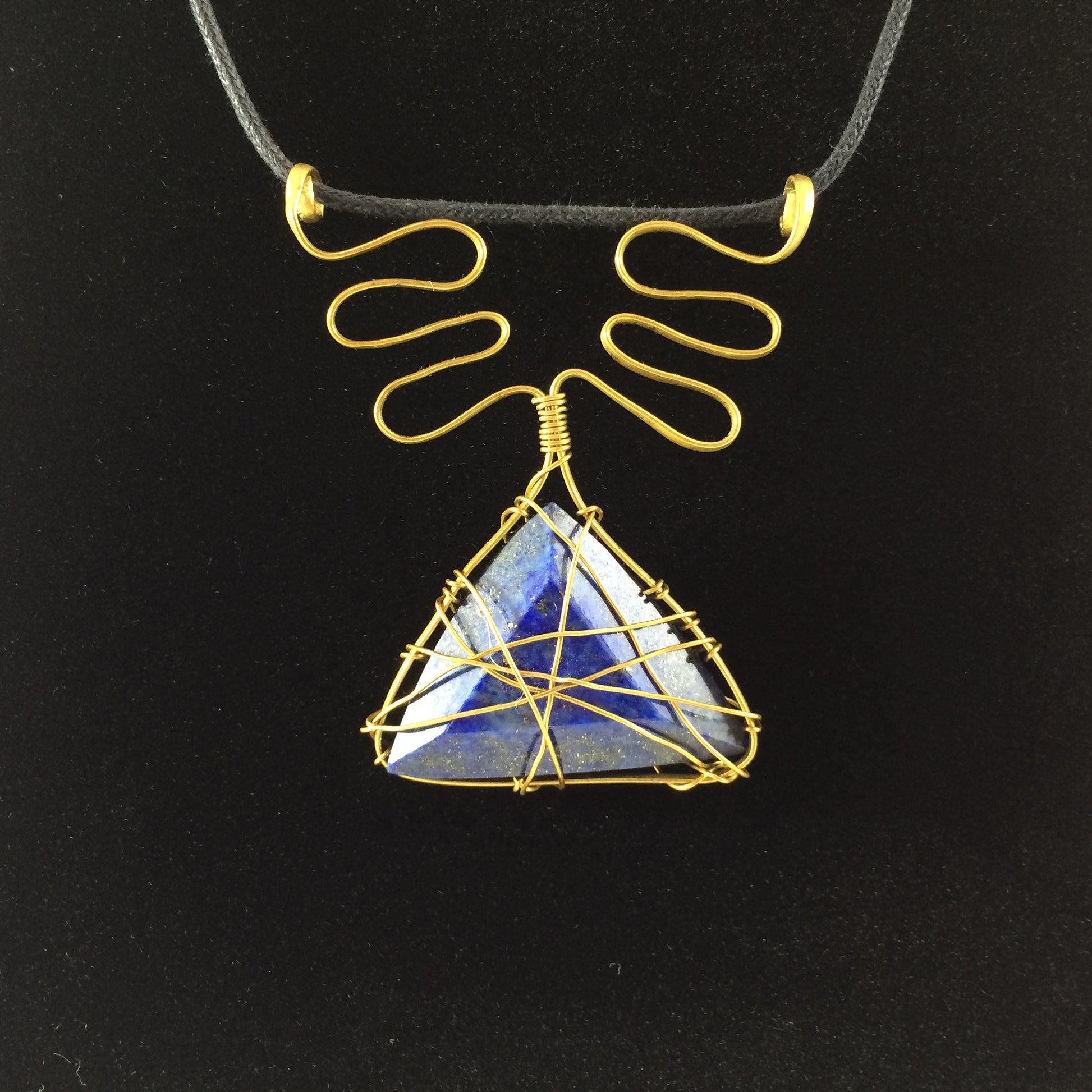 Handcrafted pendant from brass wire and blue lapis stone