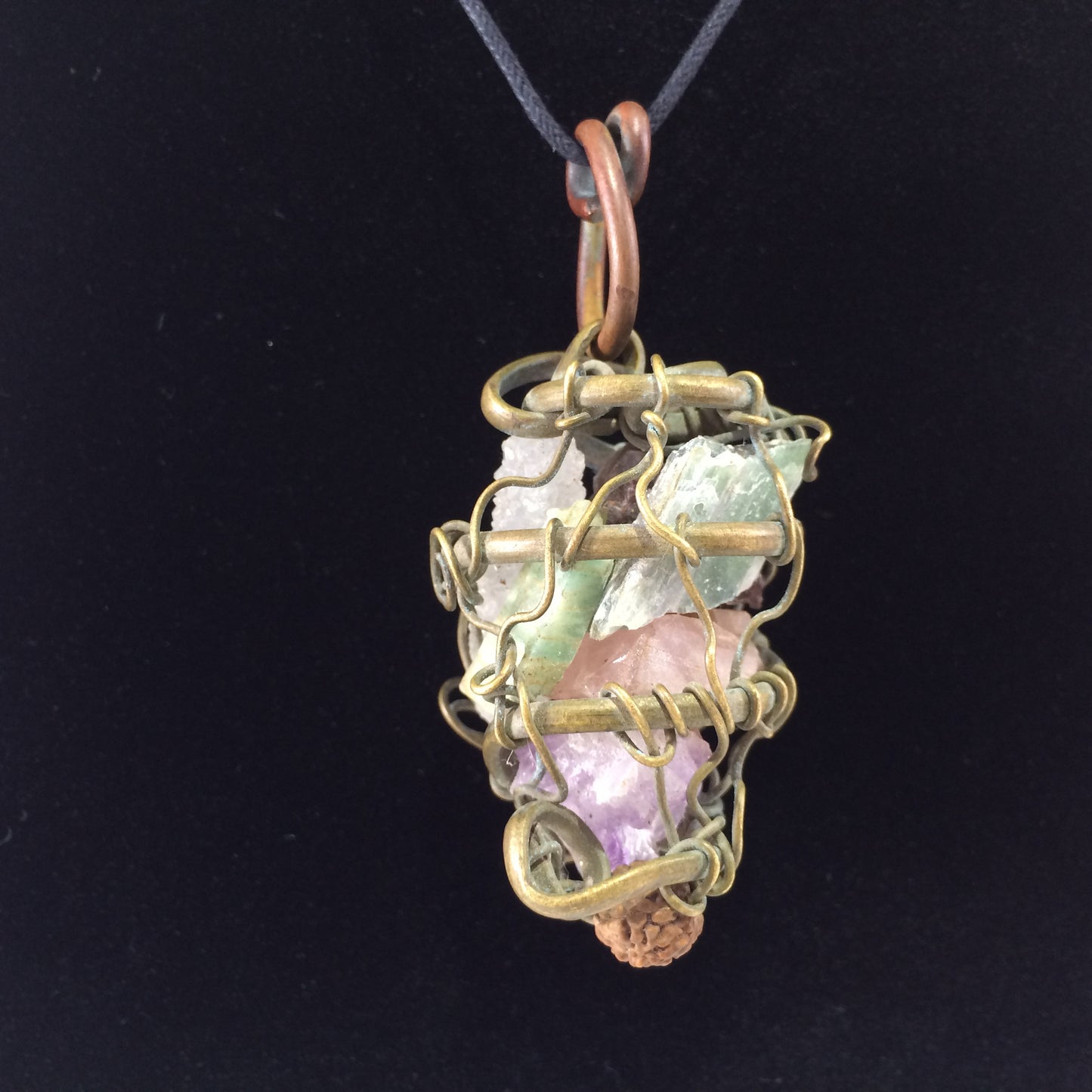 Pendant hand crafted with brass and copper wire with multiple stones.