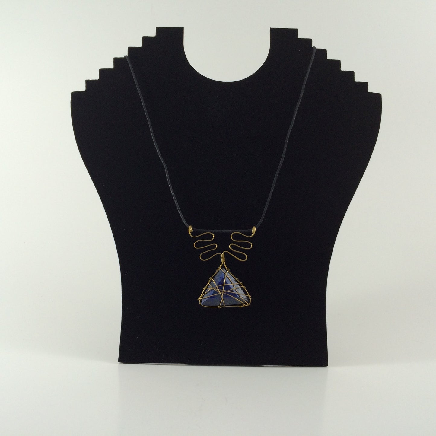 Handcrafted pendant from brass wire and blue lapis stone