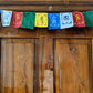 Prayer Flag Om Mani Padme Hum Cotton Mini on home door closeup